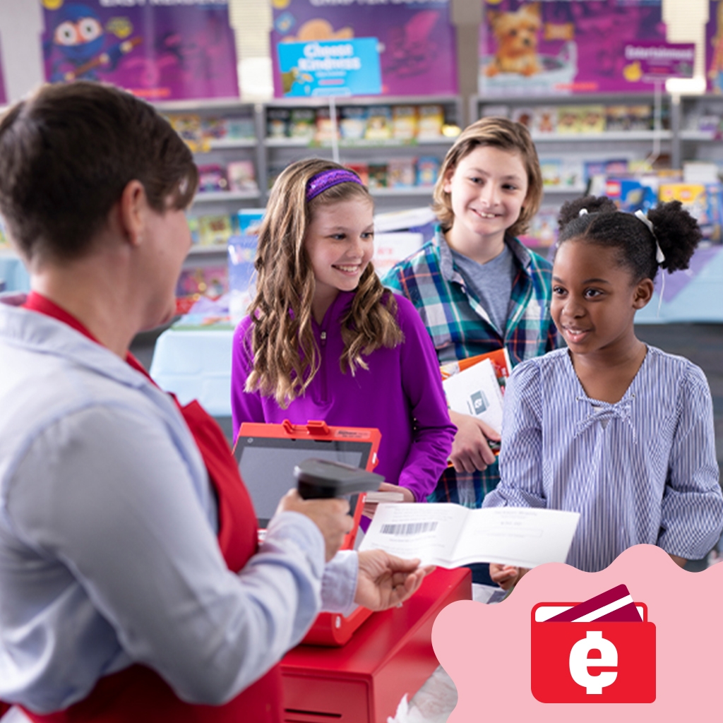 Students check out at the Book Fair while a volunteer scans their items. The eWallet logo is in the bottom corner.