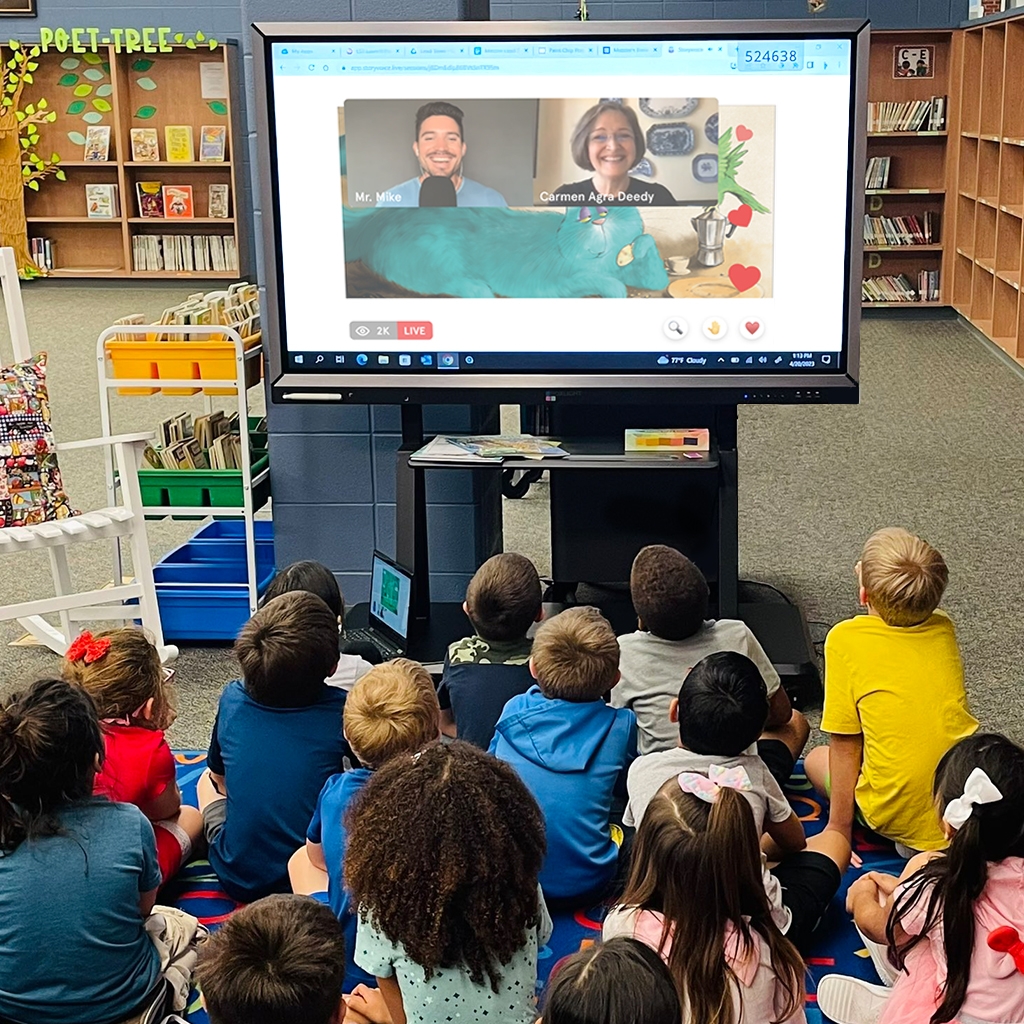 A group of students are seated in a library at a Storyvoice event