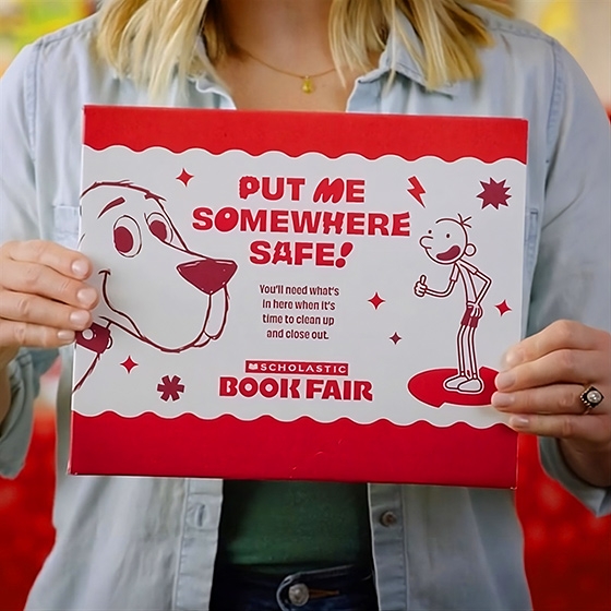 A pair of hands hold up the PUT ME SOMEWHERE SAFE! envelope