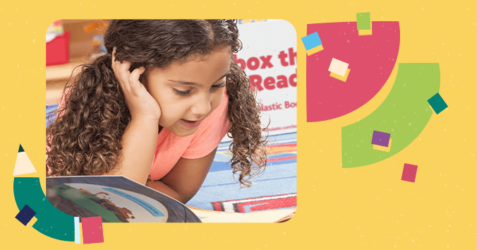 Girl reading a picture book in the classroom.